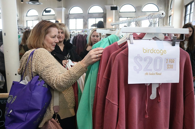 Shoppers check out clothing deals.