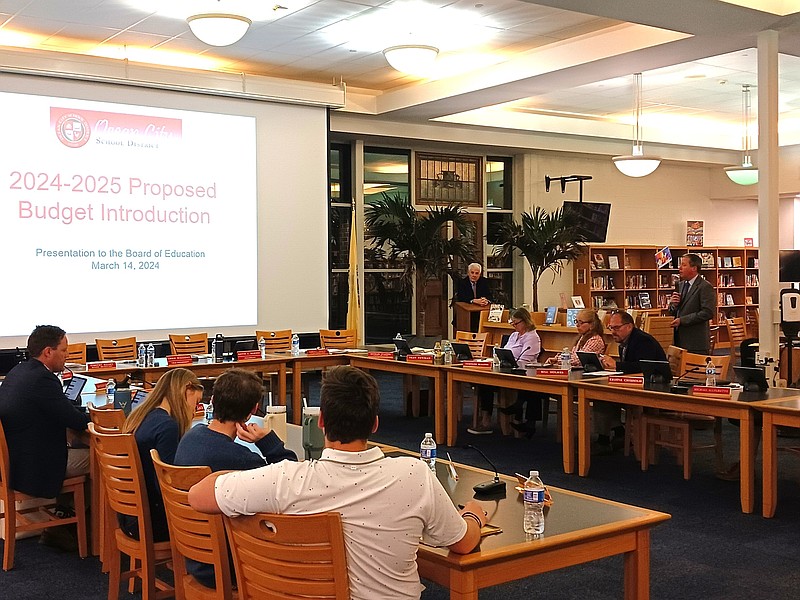 School Business Administrator Tim Kelley, standing at right, outlines key points in the proposed school budget.