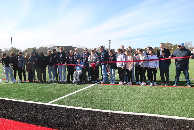 Student athletes and officials cut the ribbon to the Tennessee Avenue Sports Complex. 