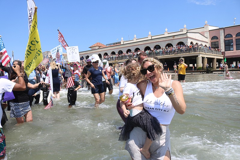 White Lotus owner Lisa Catrambone flashes a smile and a wave.