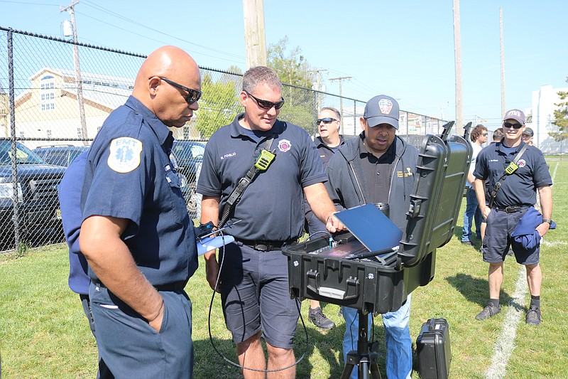 Firefighters watch the flight map as Atlantic City Firefighter and flight instructor Jamieson Allen operates the drone.