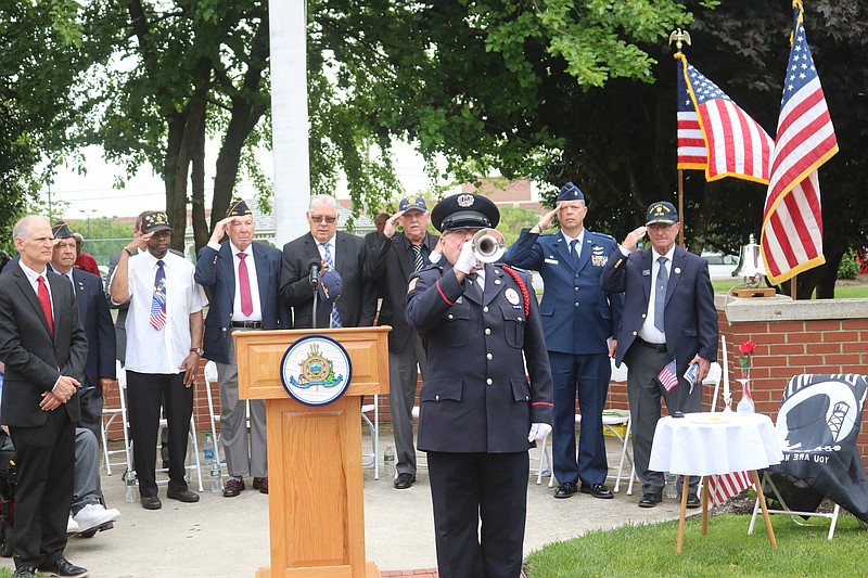 Bugler Greg Murphy performs "Taps" during the 2024 Memorial Day service.