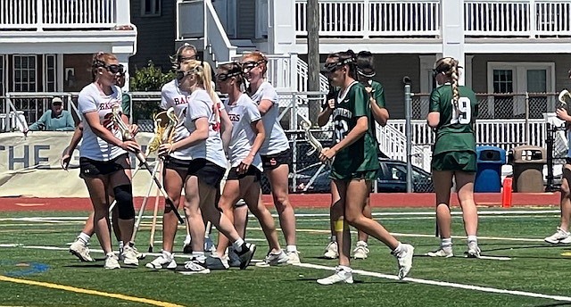 Ocean City's players, in white, celebrate a goal.