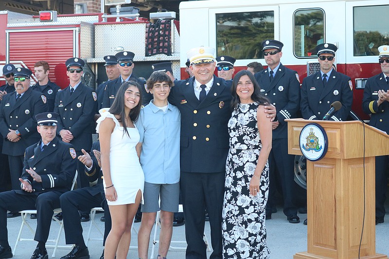 Bernard Walker is joined by his wife, Rachel, and children, Lea and Joey, after being sworn in as the new fire chief. 