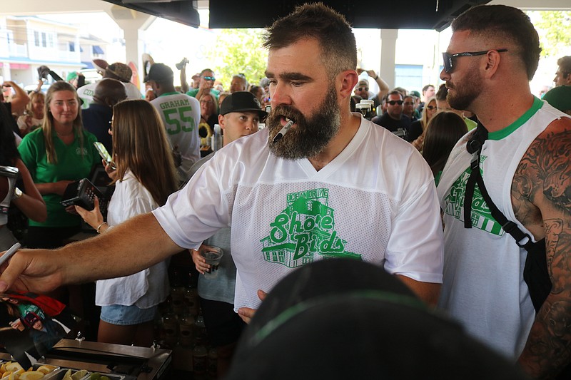 Jason Kelce signs autographs during his celebrity bartending role.