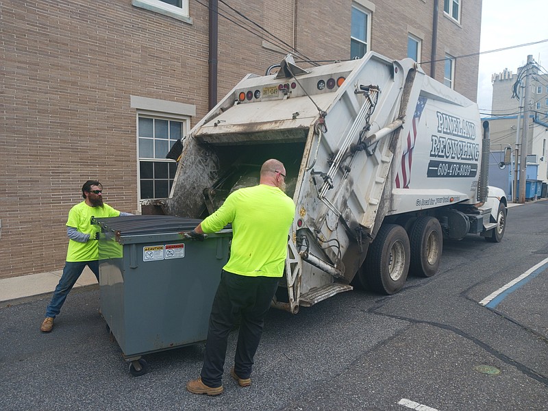 A trash truck makes pickups in Ocean City.