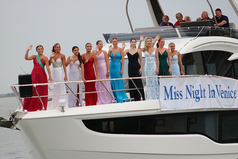 The 10 Miss Night in Venice contestants wave to spectators during the annual boat parade Saturday.