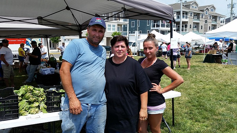 Al and Sandy Izzi and their daughter, Heather, sell produce grown at their farm in neighboring Ocean View.