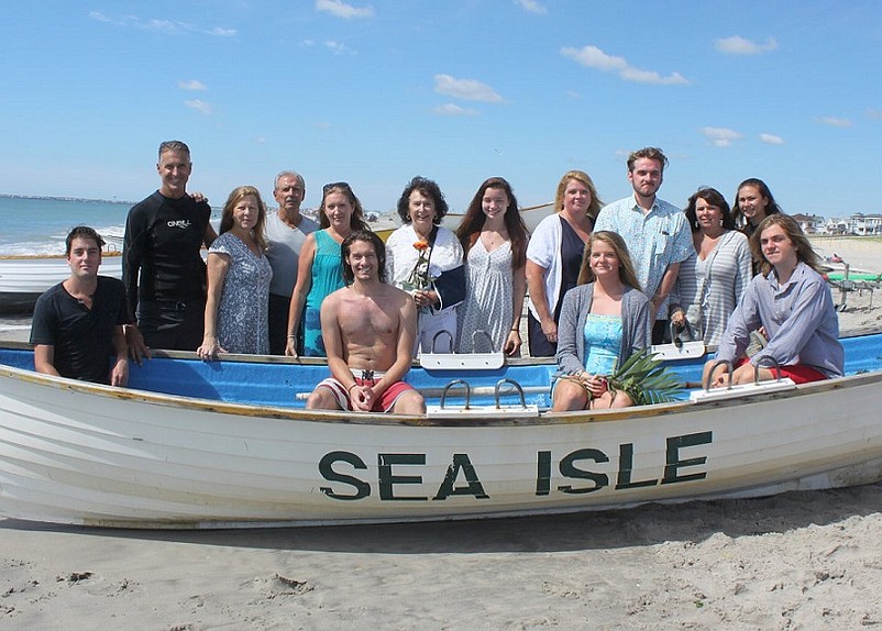 Members of the Bowen Family are shown on Sea Isle City’s 43rd Street Beach following a memorial service for Joe and Hughie Bowen – among them are Joe’s wife, Alma Bowen (standing, center, holding flower), and her son, Brian Bowen (standing, far left).