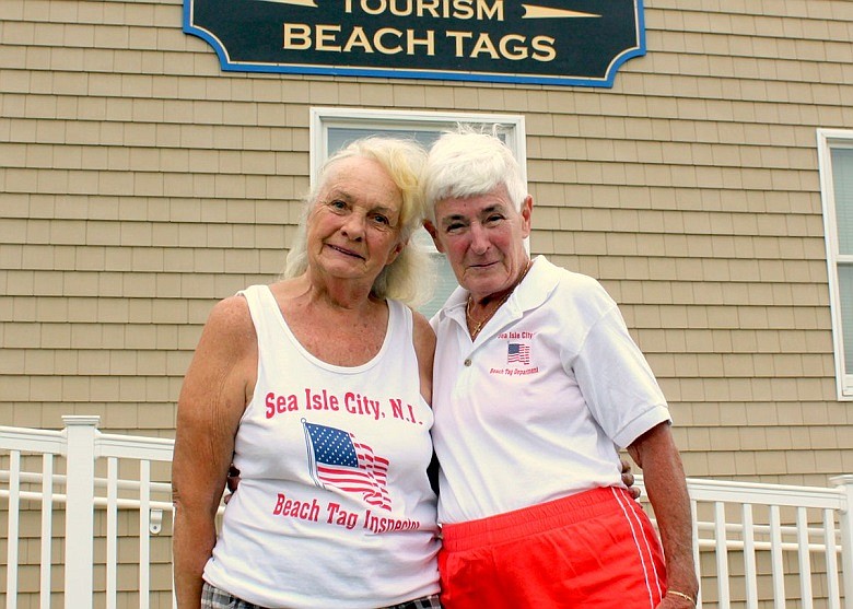 Marilyn Bennett (at left), a year-round resident of Sea Isle City for more than 20 years, is enjoying her 25th summer as a Sea Isle City Beach Tag Inspector – a job she has held longer than anyone else in the resort’s history.  Mrs. Bennett is shown in front of the Welcome Center Beach Tag Office with Beach Tag Director (and long time friend) Pat Allen.  