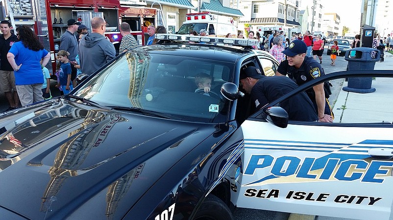 A young boy hopped behind the wheel of a Sea Isle City police car with some help from two officers.