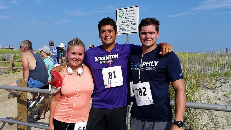 Mike Fee, 24, of Richboro, Pa., (center) was offered $300 from a group of old high school and college friends if he could finish the race. He was joined by friends and fellow runners Anna Schultz, 23, of Montgomeryville, Pa., and Rob Watts, 23, of Newtown, Pa.