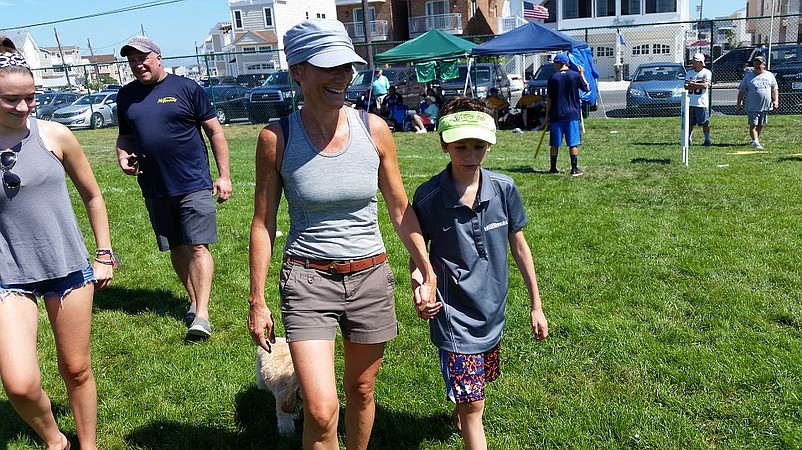 Carol McGowan walks with her 11-year-old son, Owen, who has autism.