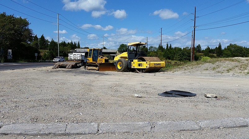 Construction equipment stands ready for work that resumes this week.