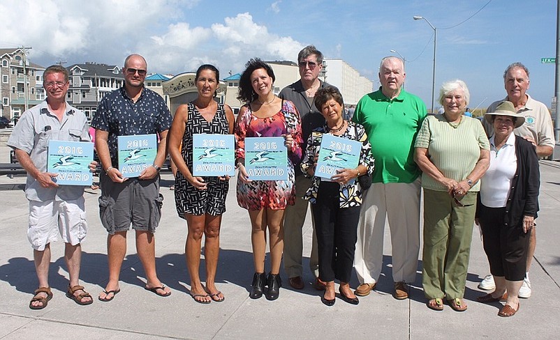 On September 18, the Sea Isle City Environmental Commission distributed 2016 Beautification Awards to local property owners who have improved or maintained the appearance of their homes. Shown receiving awards are (from left) Dennis Painter (accepting for the Sturgis family, 2315 Landis Avenue),  Chris Pigeon (217 - 43rd Street), Vicki Feeney (accepting for the Sea Isle City Department of Public Works, which recently improved the grounds of Sea Isle City Library), Karyn Reade and Craig Jenks (209 – 48th Street), and Chris and Gerald Donohue (225 – 56th Street).  Also shown are (from left) Environmental Commission member Eleanor Moore, Environmental Commission Chairperson Annette Lombardo, and Beautification Award organizer Dudley McGinty.