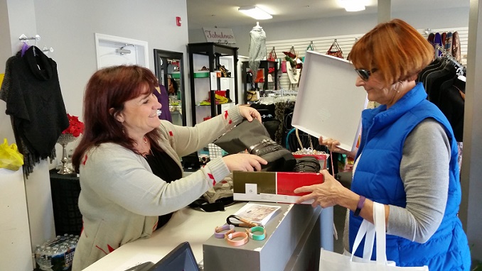 Groovy Girlz owner Colleen Buch, left, one of the organizers of Girls Weekend, waits on customer Carol Maxwell, of Virginia Beach, Va.