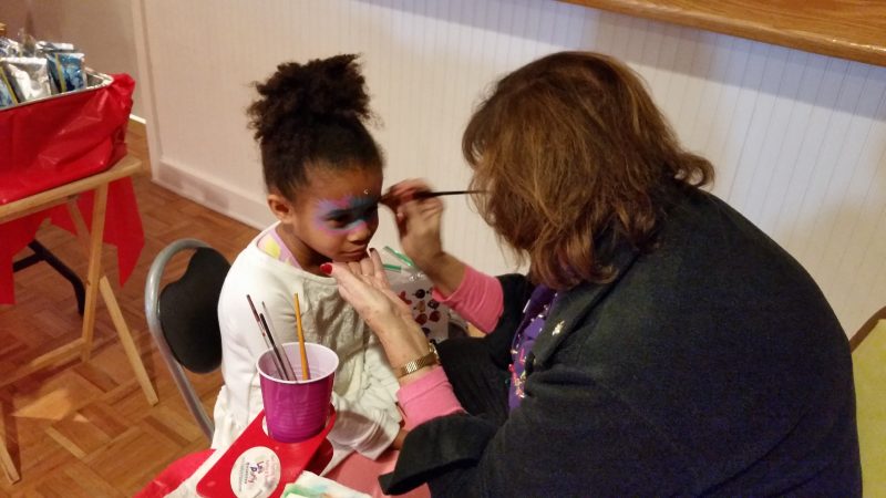 Aubrey McCatty, 6, of Dennis Township, has her face painted by Jinny Mulford of Let's Party Painters of Corbin City.