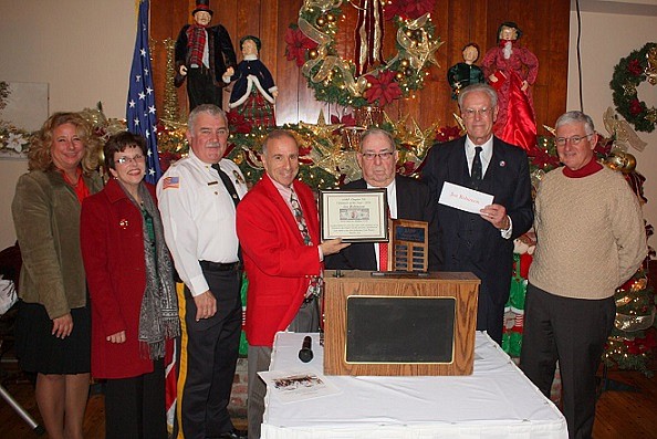 During AARP Chapter 710’s annual Christmas Luncheon, Joe Robinson, of Sea Isle City, was declared “Chapter 710 Volunteer of the Year.”  Mr. Robinson (third from right) has served as Chapter 710’s Treasurer for the past five years, he is an active member of Saint Joseph Catholic Church, and he’s well-respected throughout Sea Isle City.  He is shown during the award presentation on December 8 with (from left) Cape May County Surrogate Susan Sheppard, Esq., Cape May County Clerk Rita Marie Fulginiti, Cape May County Undersheriff Robert Nolan, Sea Isle City Mayor Leonard Desiderio, Chapter 710 President Frank Roach, and Chapter 710 Vice-President Bill Keller. (Photo provided by Sea Isle City Public Relations Office)