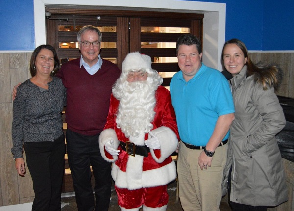 Santa Claus was on hand to thank everyone who participated in the Holiday Dash, including (from left) Debbie & Joe Brennan and Maureen & Bob Baldini, all of Sea Isle. Donations collected during the Holiday Dash benefitted Mayor Desiderio’s Holiday Toy and Food Drive.