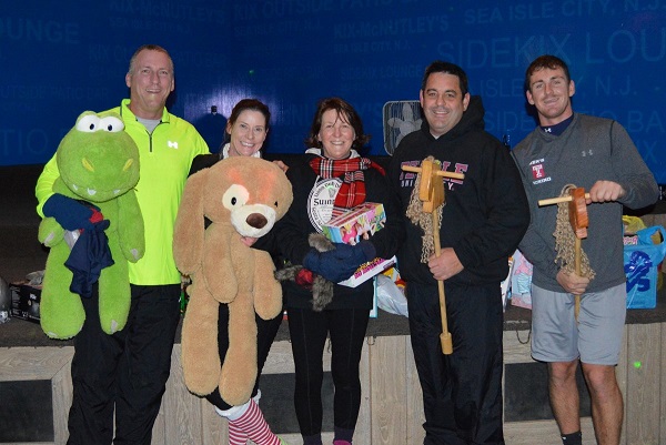 Tom ; Laura Barrett of Sea Isle City, Linda Matousch-Rau of Belleplain, and Don & Nick Matousch of Upper Township hold their toy donations following the Holiday Dash.