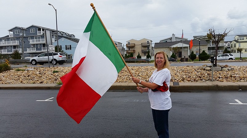 Lynda Fraizer, a member of the Italian-American Club Women's Auxiliary, waves the Italian flag at a recent parade. She is standing directly across the street from the club at 309 John F Kennedy Blvd, Sea Isle City, NJ 08243