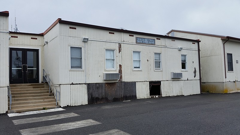 The blighted school trailers are marred by peeling paint and holes in the siding.