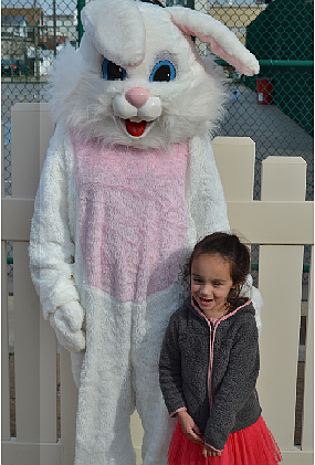 Avery McDowell posing for her picture with the Easter bunny