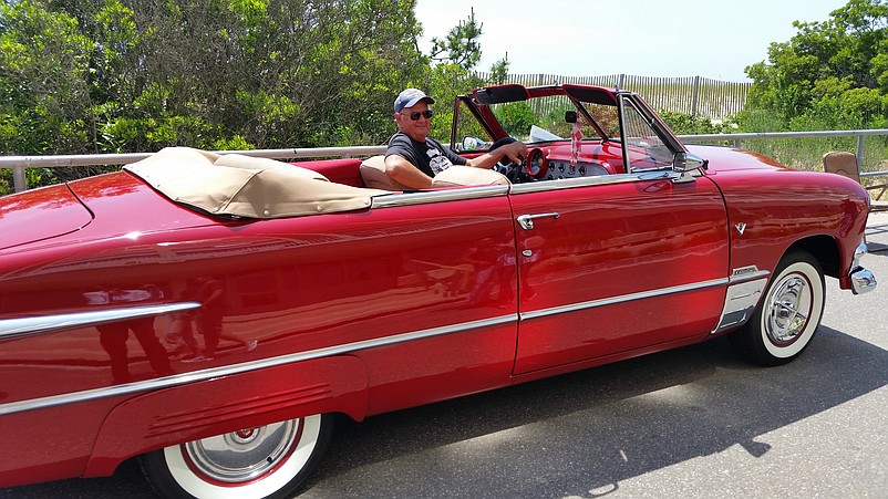 Tim Cavacini, of Egg Harbor Township, sits behind the wheel of his 1951 Ford Custom convertible.