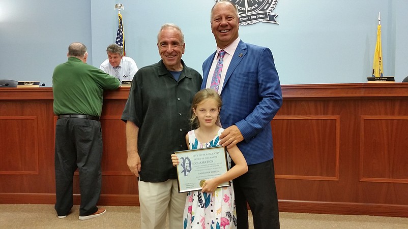 Samantha Morris, 7, who played mayor for the day, was chaperoned around City Hall by Sea Isle Mayor Leonard Desiderio, left, and her father, Bob Morris.