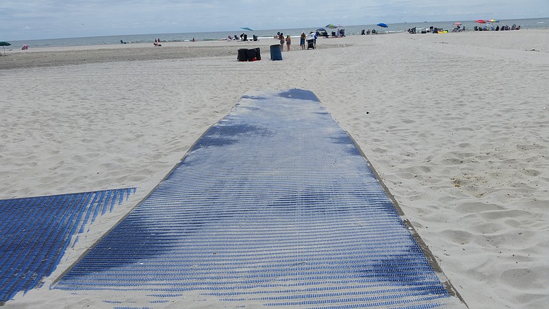 A Mobi-Mat lies on top of the sand last summer, making it easier to walk across the beach.