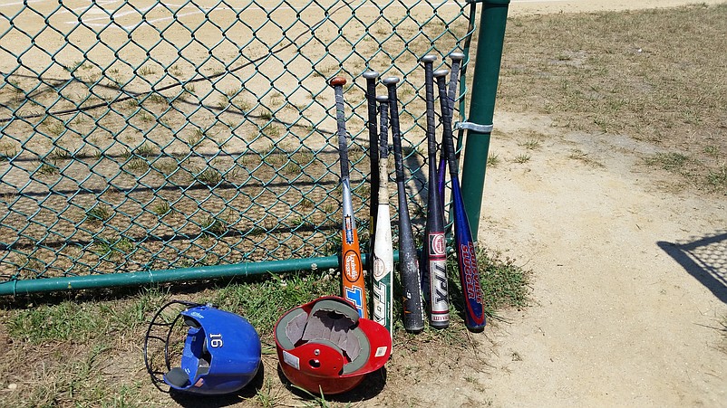 Baseball bats and helmets are ready for use at Dealy Field.