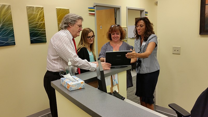 Dr. Roeltgen consults with staff members at the facility. More employees are expected to be added in about six months.