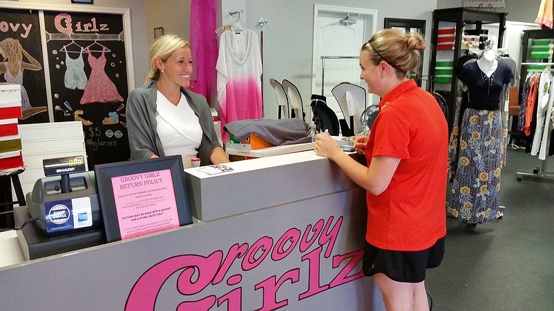 Saleswoman Nikki Trofa, left, waits on customer Brie Anzideo, of Sea Isle City, at the Groovy Girlz boutique, one of the shops that will participate in the discount shopping card program in October.