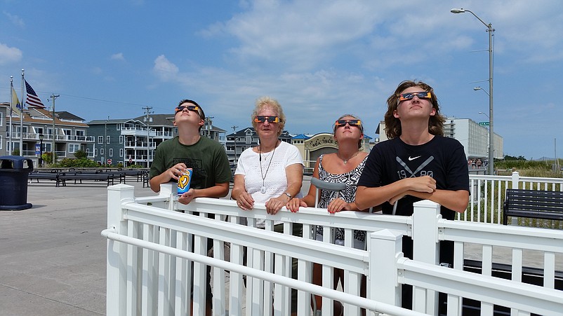 Bette Kurkis is joined by her grandchildren, Noah, Shelby and David Cressman, while checking out the eclipse from the Promenade.