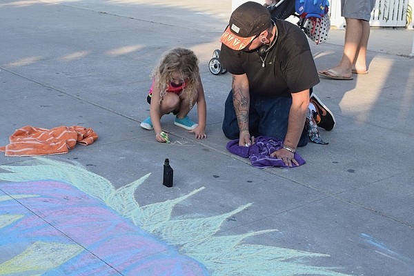 5 year old AJ Wilson from Centreville, MD. signs her name at the bottom of the design she helped Bernie with