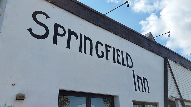 In simple black letters, the Springfield Inn name adorns the side of the building on 43rd Street.