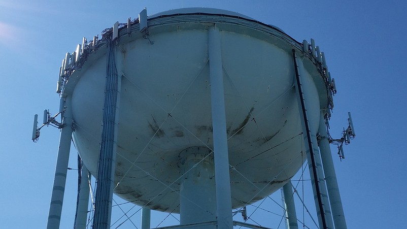 The underside of the tower shows scuffing and rust streaks, reflecting the need for a repainting.