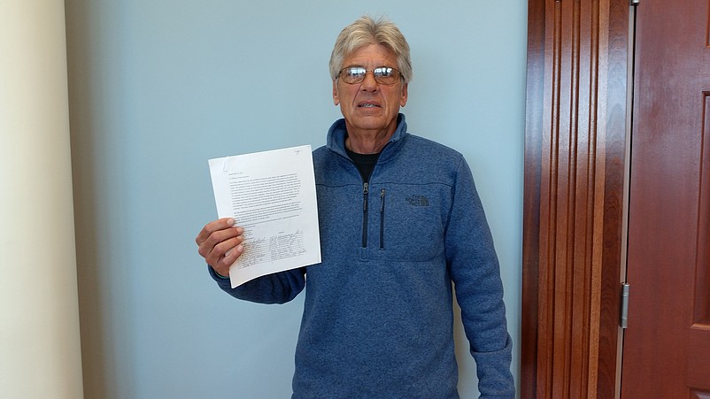 Terry Mason holds a copy of the petition that he submitted to City Council in November 2017.