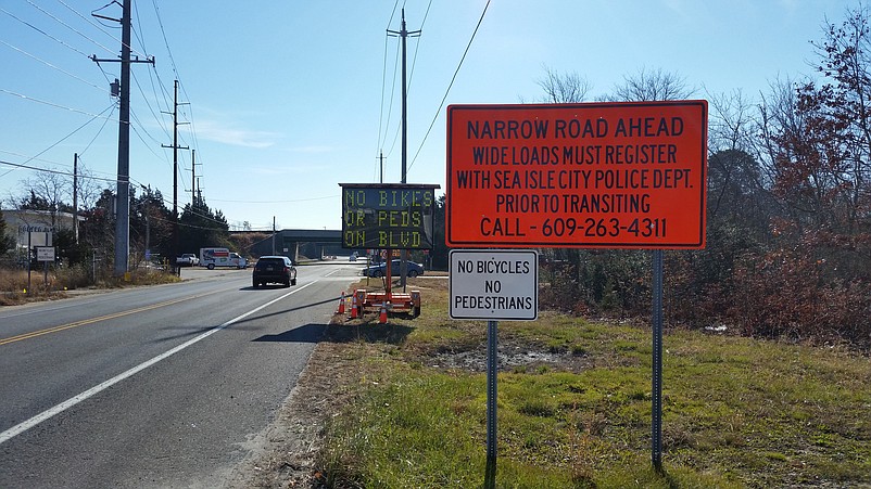 Motorists heading toward Sea Isle encounter signs warning them of the narrow road caused by the construction.