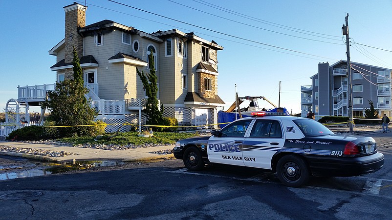 A Sea Isle police car blocks access to the scene Friday in the aftermath of the fire.