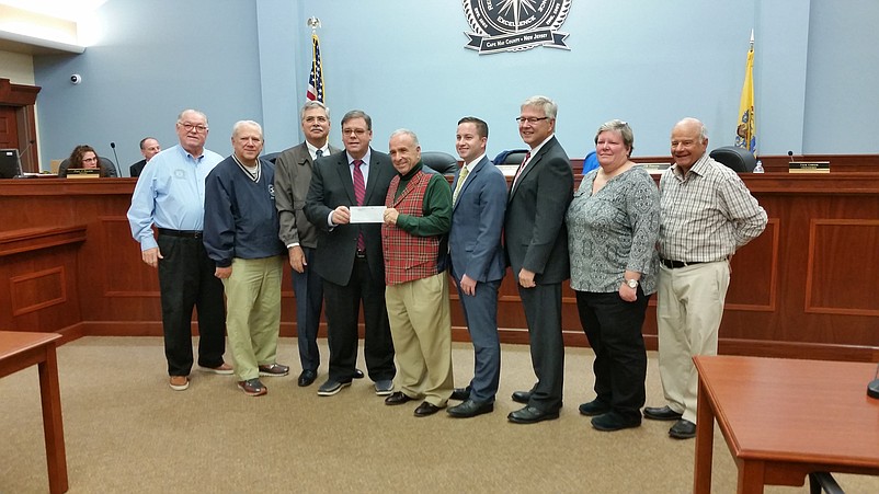 Joseph Maressa Jr., co-managing member of Boardwalk Settlement Services LLC, presents a $1,000 donation to Mayor Desiderio and other city officials.