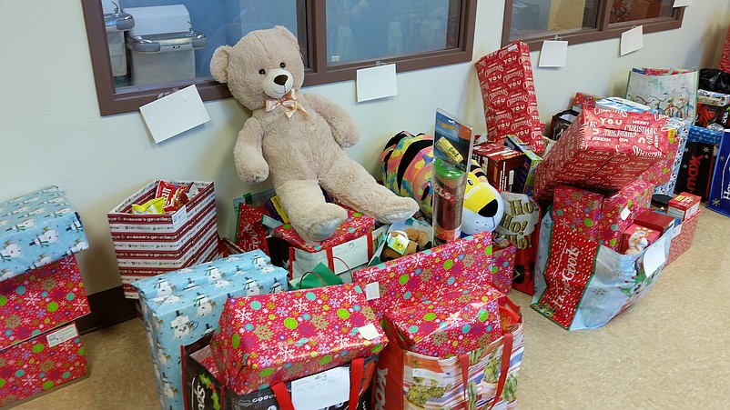 A room in City Hall brims with colorfully wrapped gifts, stuffed animals and boxes of food.