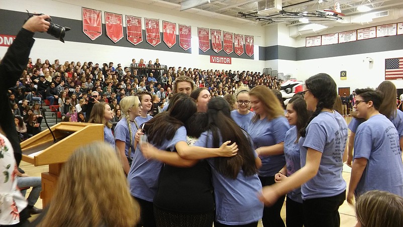 Some of Amy T. Andersen's students give her a huge hug. 