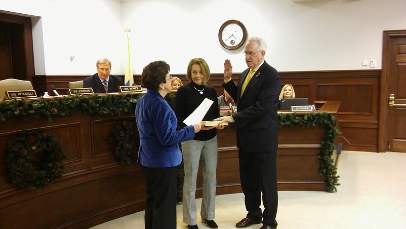 Freeholder Jeffrey Pierson is sworn in by County Clerk Rita Marie Fulginiti while colleague Virginia Tomlin holds the Bible. 