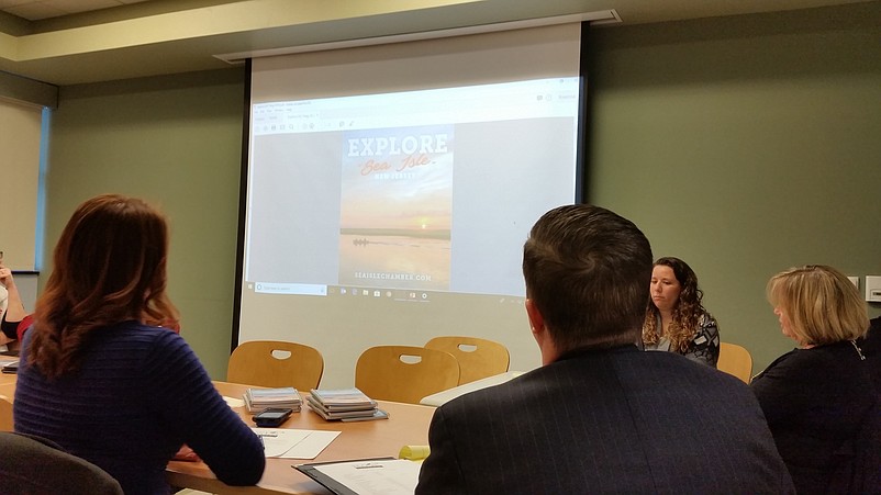 Board members of the Chamber of Commerce get their first look at the new publication during their monthly meeting Tuesday.