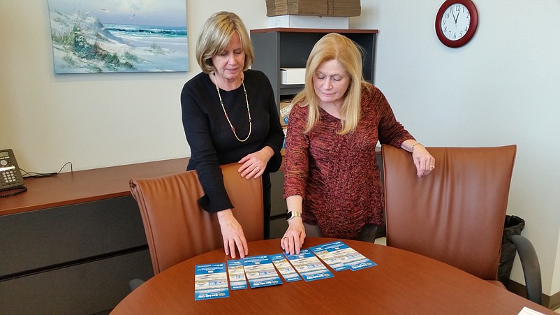 Marketing consultant Mickey Coskey, left, and tourism representative Diane Merson look over some of the promotional literature for Sea Isle City's summer publicity campaign.