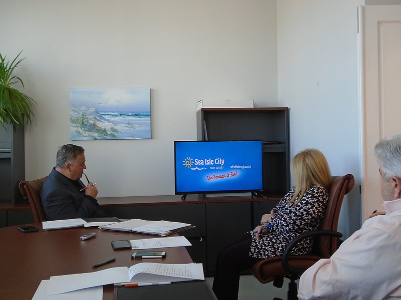 James Bennett, chairman of the Tourism Commission and  tourism representative Diane Merson watch a vignette Thursday of the city's vacation theme "The Forecast is Fun!" 