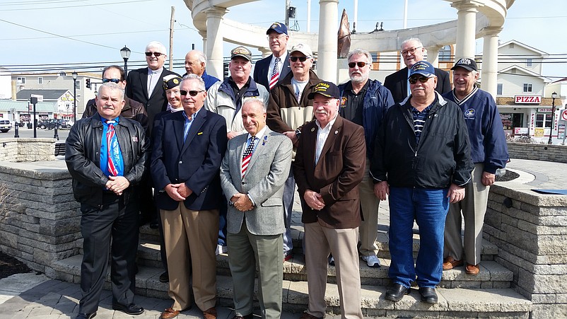 Sea Isle dignitaries join with Vietnam veterans on the steps of the monument at Veterans Memorial Park.