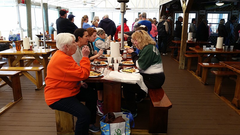 Volunteers dine at a complimentary post-cleanup buffet sponsored by Mike's Seafood &amp; Dock Restaurant.