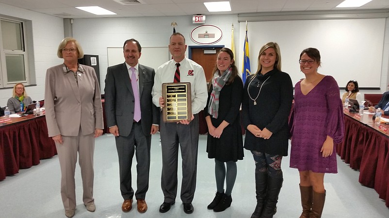 Ocean City Intermediate School Principal Geoffrey Haines, holding plaque during a 2017 awards ceremony at a Board of Education meeting, has been named the winner of the 2018 AtlantiCare Healthy Educator Award.